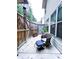 Cozy outdoor patio featuring a chair with cushion and an ottoman, adjacent to the house at 2439 Muirfield Pl, Atlanta, GA 30337