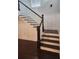 Elegant staircase with dark wood steps and white trim, adding a touch of sophistication at 2439 Muirfield Pl, Atlanta, GA 30337