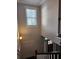 Bright staircase with high ceilings and natural light from the window at 2439 Muirfield Pl, Atlanta, GA 30337