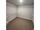 Spacious walk-in closet features wire shelving on all sides and neutral carpeting at 2439 Muirfield Pl, Atlanta, GA 30337