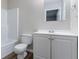 This bathroom features a toilet, vanity, and shower with white tile at 310 Rippling Brook Trce, Palmetto, GA 30268