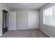 This bedroom has neutral carpet, a window with natural light, and a closet at 310 Rippling Brook Trce, Palmetto, GA 30268