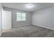 This bedroom features neutral carpet and natural light from the window at 310 Rippling Brook Trce, Palmetto, GA 30268