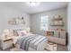This bedroom has furniture, carpet, and a window with natural light at 310 Rippling Brook Trce, Palmetto, GA 30268