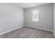 This bedroom features neutral carpet and natural light from the window at 310 Rippling Brook Trce, Palmetto, GA 30268