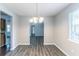 Dining room with a chandelier above hardwood floors at 310 Rippling Brook Trce, Palmetto, GA 30268