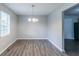 Dining area with modern light fixture and hardwood flooring at 310 Rippling Brook Trce, Palmetto, GA 30268