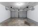 Spacious two car garage with gray doors, automatic openers, and concrete floor at 310 Rippling Brook Trce, Palmetto, GA 30268
