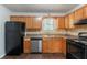 Kitchen featuring wooden cabinets, stainless steel appliances, and dark plank flooring at 310 Rippling Brook Trce, Palmetto, GA 30268