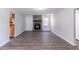 Living room boasting dark plank flooring and a stone fireplace at 310 Rippling Brook Trce, Palmetto, GA 30268
