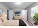 This main bedroom has carpet and is decorated with a dresser, bed, and plant at 310 Rippling Brook Trce, Palmetto, GA 30268