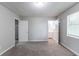 This main bedroom has neutral carpet, natural light, and an attached bathroom at 310 Rippling Brook Trce, Palmetto, GA 30268
