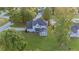 Back aerial view showcasing sprawling backyard, mature trees, and house design with charming details at 4186 Stillwater Pt, Ellenwood, GA 30294
