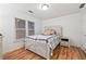 Charming bedroom features wood floors, a cozy bed, and natural light from the window at 4186 Stillwater Pt, Ellenwood, GA 30294
