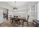 Cozy dining area featuring a modern light fixture and window with natural light and gray color scheme at 4186 Stillwater Pt, Ellenwood, GA 30294