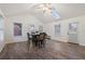 Bright dining room featuring wood-look flooring, a skylight, multiple windows, and a modern dining set at 4186 Stillwater Pt, Ellenwood, GA 30294