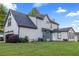 Well-manicured backyard with vibrant green lawn, beautiful home exterior, and natural landscaping at 4186 Stillwater Pt, Ellenwood, GA 30294
