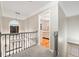 Upstairs hallway features a decorative railing and a glimpse into a bedroom at 4186 Stillwater Pt, Ellenwood, GA 30294