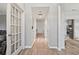 Bright entryway with hardwood floors and decorative glass door, leading to various rooms at 4186 Stillwater Pt, Ellenwood, GA 30294