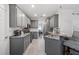 Well-equipped kitchen featuring granite countertops, stainless steel appliances, and gray cabinetry at 4186 Stillwater Pt, Ellenwood, GA 30294