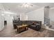 Open-concept living room showcases wood-look flooring and a comfortable sectional sofa, adjacent to the kitchen at 4186 Stillwater Pt, Ellenwood, GA 30294