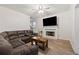 Inviting living room features a fireplace, modern ceiling fan, and a comfortable, oversized sectional sofa at 4186 Stillwater Pt, Ellenwood, GA 30294