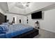 Luxurious main bedroom with vaulted ceiling, a large bed, and a modern media setup at 4186 Stillwater Pt, Ellenwood, GA 30294