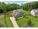 Aerial view of a suburban home with a large yard and a well-maintained driveway at 107 Equest Dr, Canton, GA 30115