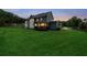 The large backyard features a deck and a vast, open lawn bordered by a wooden fence at 107 Equest Dr, Canton, GA 30115