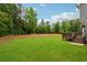 Expansive, well-maintained backyard lawn with a wooden deck and a view of the surrounding trees at 107 Equest Dr, Canton, GA 30115