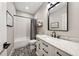 Bathroom with patterned tile floor, white subway tile shower, black fixtures, and marble countertop at 107 Equest Dr, Canton, GA 30115