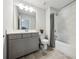 Bright bathroom with single sink, gray vanity, shower and tub combination, and gray tile floor at 107 Equest Dr, Canton, GA 30115