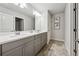 Clean bathroom featuring a grey vanity with dual sinks and tile flooring at 107 Equest Dr, Canton, GA 30115