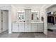Bathroom with double sinks, marble countertops, large mirrors, and walk-in closet at 107 Equest Dr, Canton, GA 30115