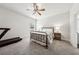 Bright bedroom with carpeted floors, a ceiling fan, neutral walls, and natural light streaming through the window at 107 Equest Dr, Canton, GA 30115