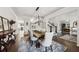 Spacious dining room with a wooden table, neutral chairs, and view of office and staircase at 107 Equest Dr, Canton, GA 30115