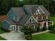 A close exterior elevation showcases the home's architectural details and well-maintained landscaping at 107 Equest Dr, Canton, GA 30115