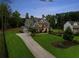 This exterior elevation displays a spacious home with a large front yard, and a paved driveway at 107 Equest Dr, Canton, GA 30115
