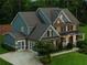 Stately two-story home with a brick facade, side-entry garage, and meticulously landscaped front yard at 107 Equest Dr, Canton, GA 30115