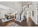 Elegant foyer with hardwood floors, staircase, and dining room view with chandelier at 107 Equest Dr, Canton, GA 30115