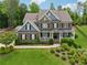 Beautiful home with a brick facade, covered porch, and meticulously landscaped front yard at 107 Equest Dr, Canton, GA 30115