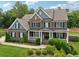 Charming two-story home boasting a brick exterior, inviting front porch, and manicured landscaping at 107 Equest Dr, Canton, GA 30115