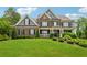 Beautiful brick home with a well-manicured lawn and covered front porch at 107 Equest Dr, Canton, GA 30115