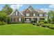 Beautiful brick home featuring a manicured lawn, black shutters, and a welcoming front porch at 107 Equest Dr, Canton, GA 30115