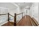 Upstairs hallway with hardwood floors and white trim, leading to various rooms at 107 Equest Dr, Canton, GA 30115