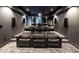 Cozy home theater is equipped with tiered seating, large screen and projector at 107 Equest Dr, Canton, GA 30115