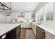 White kitchen features island with dark wood accents, and stainless steel appliances at 107 Equest Dr, Canton, GA 30115