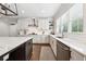 Bright kitchen featuring white cabinets, stainless steel appliances, a large island with countertop seating, and hardwood floors at 107 Equest Dr, Canton, GA 30115