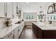 Modern kitchen featuring white cabinets, stainless steel appliances, sleek countertops, and an island for food preparation and seating at 107 Equest Dr, Canton, GA 30115
