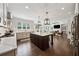 Modern kitchen open to the living area, featuring an island and stainless steel appliances at 107 Equest Dr, Canton, GA 30115